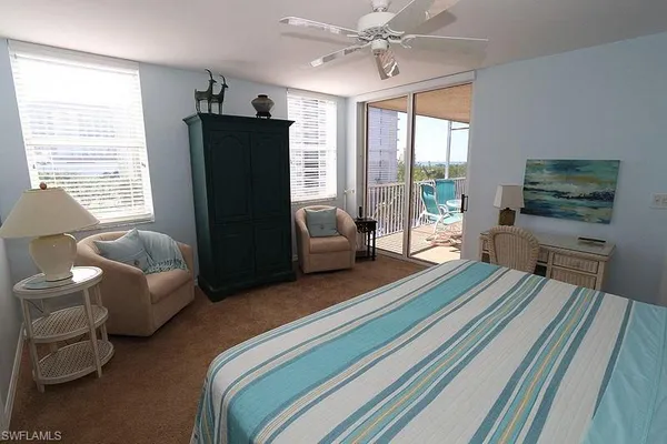 a bedroom with furniture and a flat screen tv