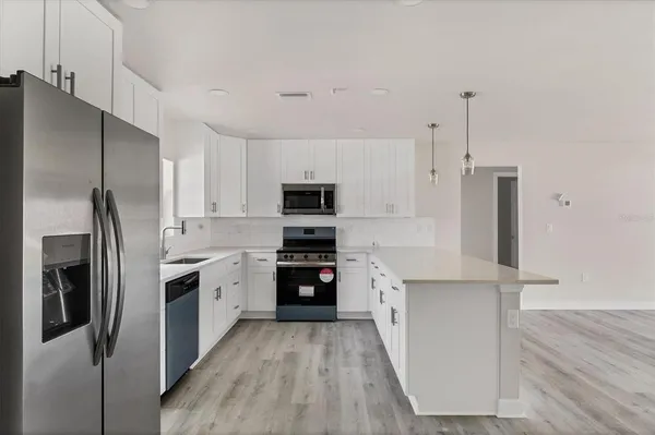 an empty room with window and wooden floor