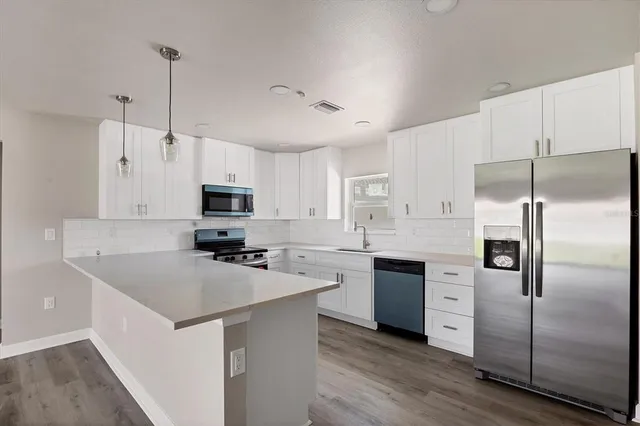 a kitchen with granite countertop white cabinets and white appliances