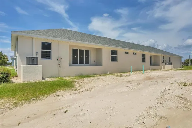 an aerial view of a house with a big yard