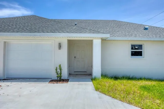 a view of a kitchen with wooden floor and a kitchen space