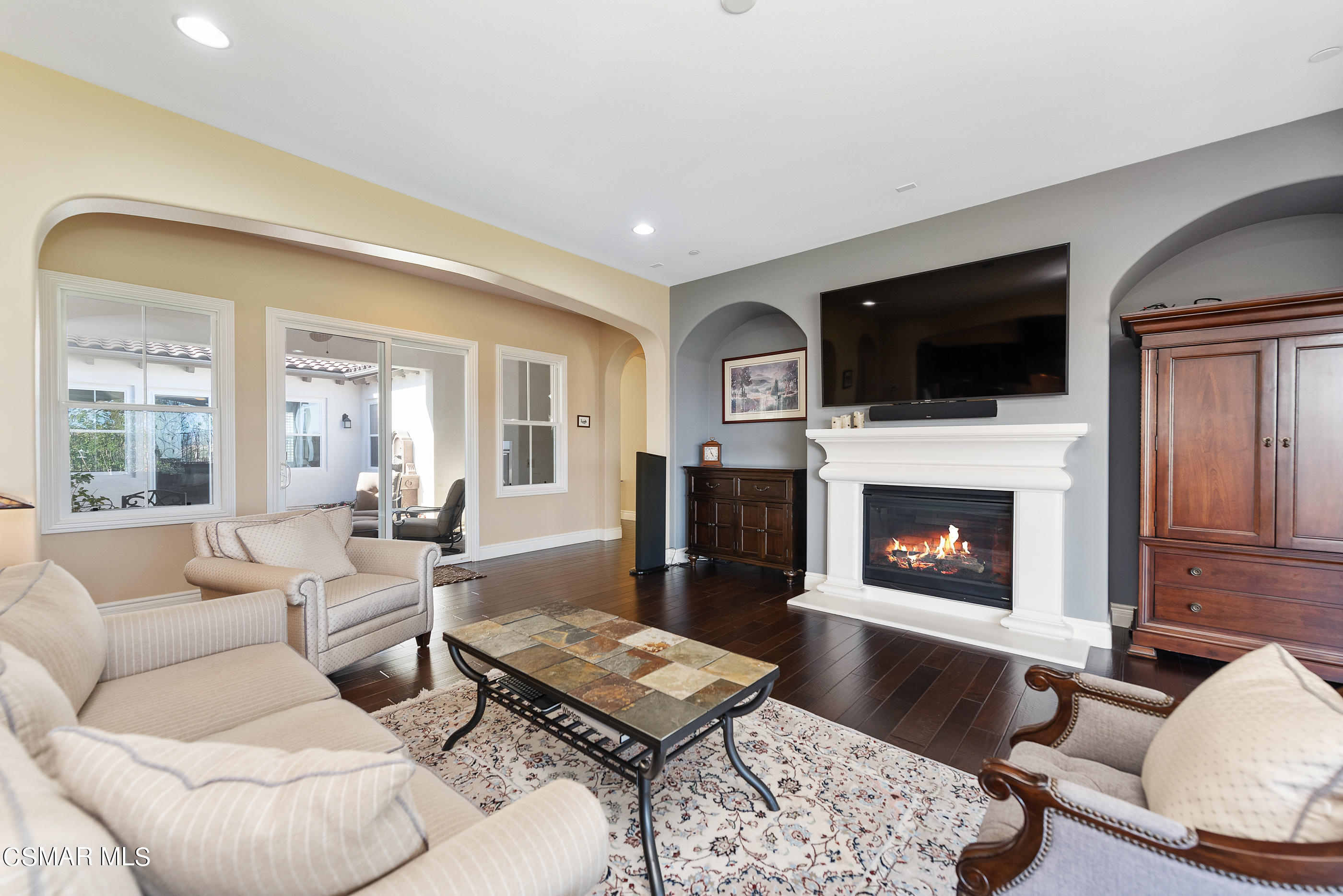 13740 Pinefield Court Moorpark, CA 93021 - Photo 12 of 62 a living room with furniture a flat screen tv and a fireplace