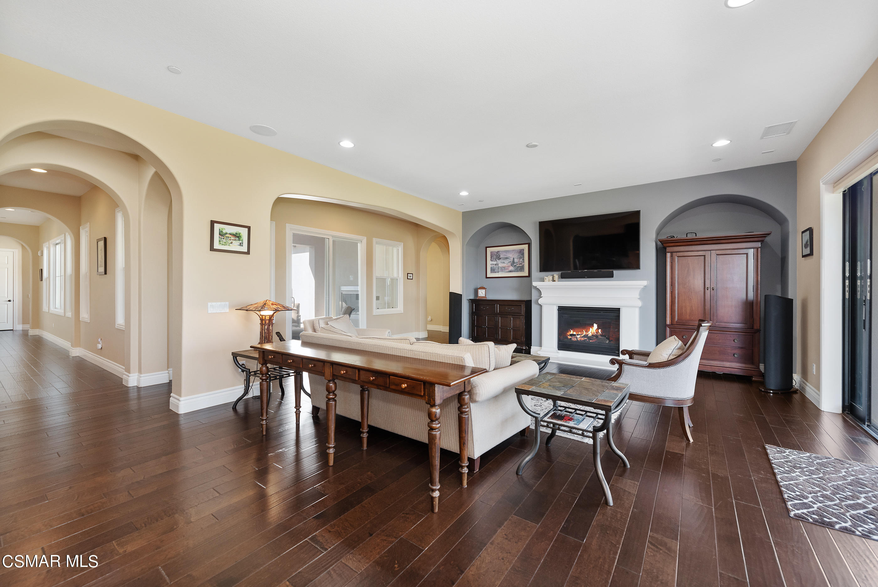 13740 Pinefield Court Moorpark, CA 93021 - Photo 13 of 62 a living room with furniture a fireplace and a flat screen tv