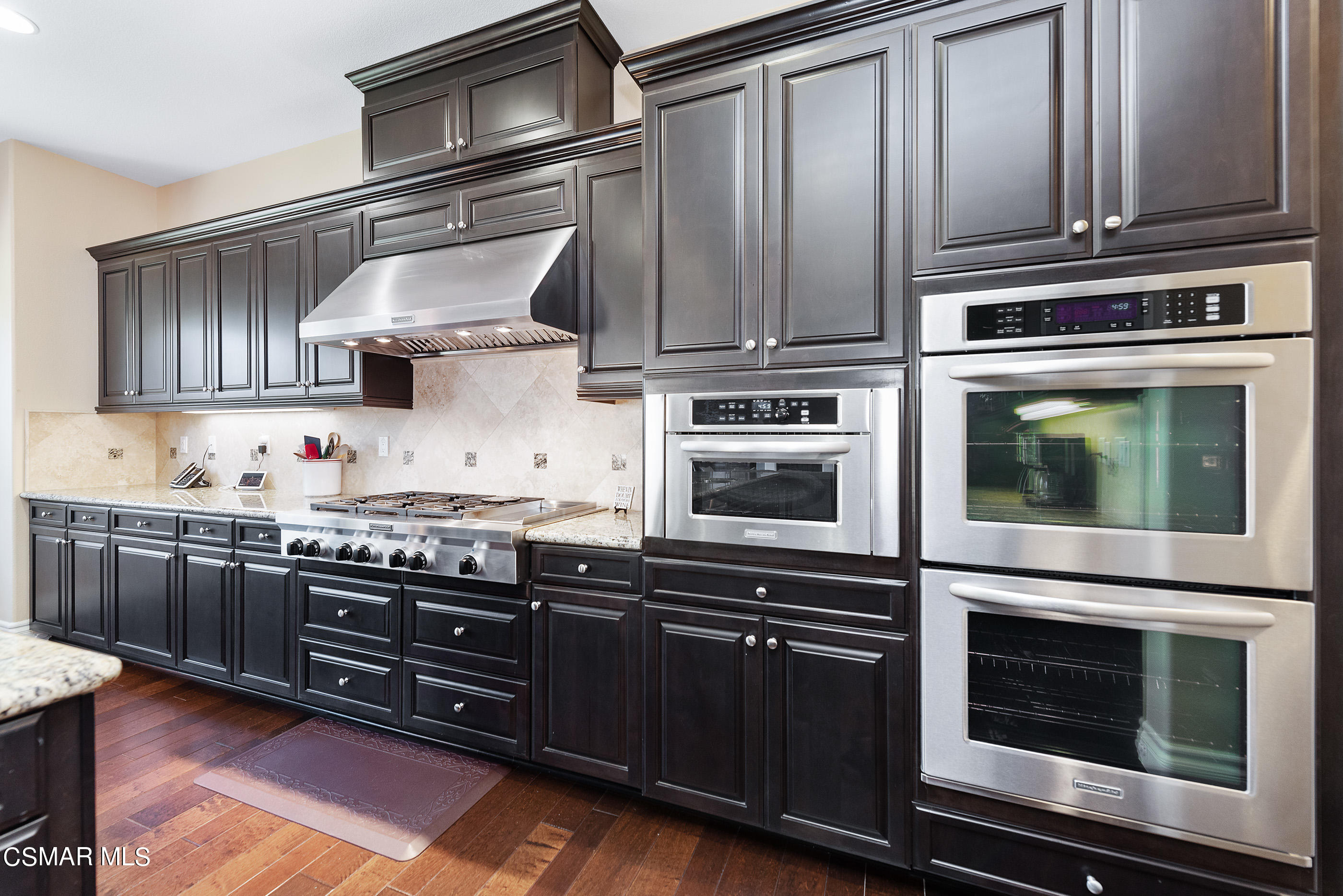 13740 Pinefield Court Moorpark, CA 93021 - Photo 16 of 62 a kitchen with granite countertop stainless steel appliances and wooden cabinets