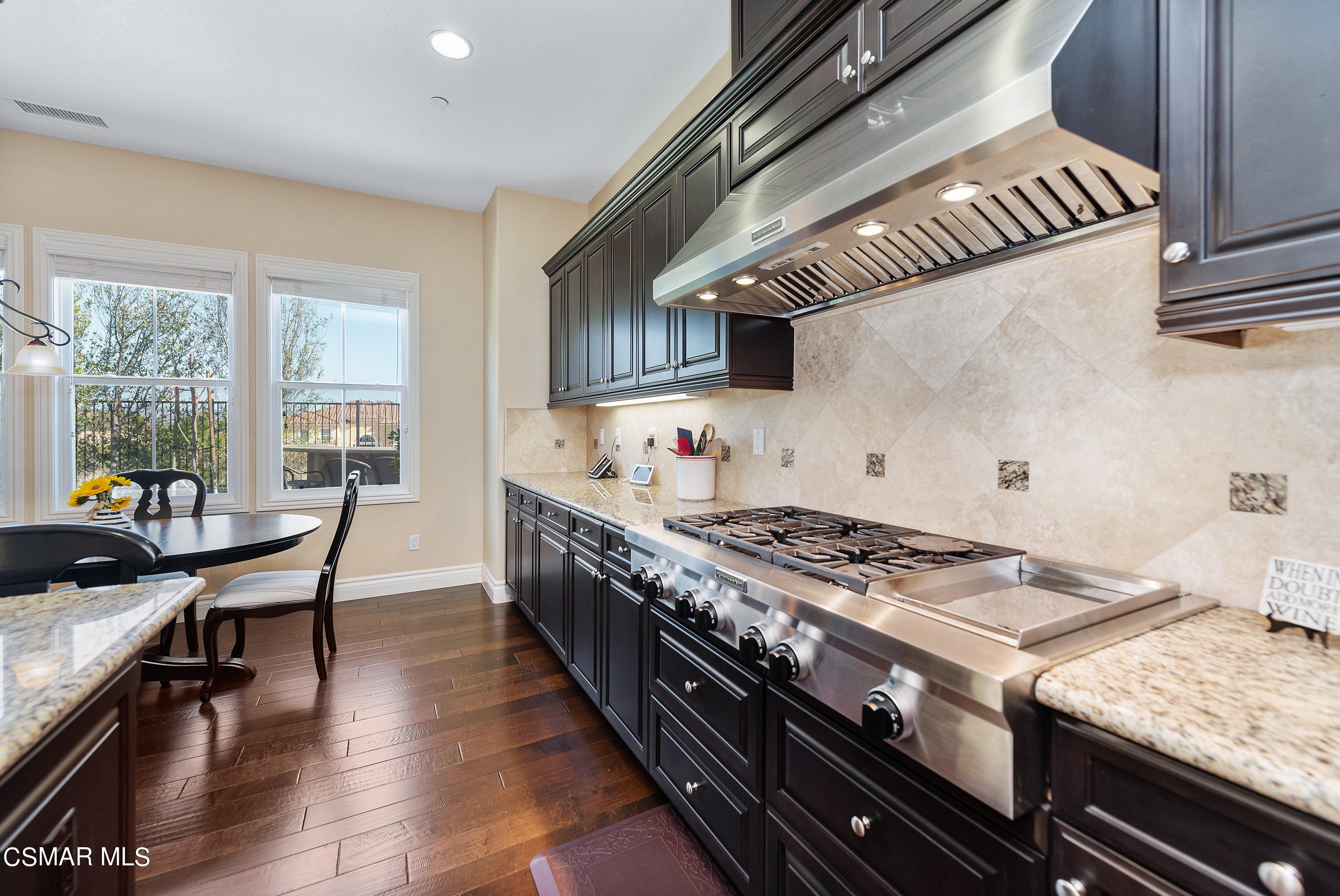 13740 Pinefield Court Moorpark, CA 93021 - Photo 20 of 62 a kitchen with stainless steel appliances granite countertop a stove a sink and a refrigerator