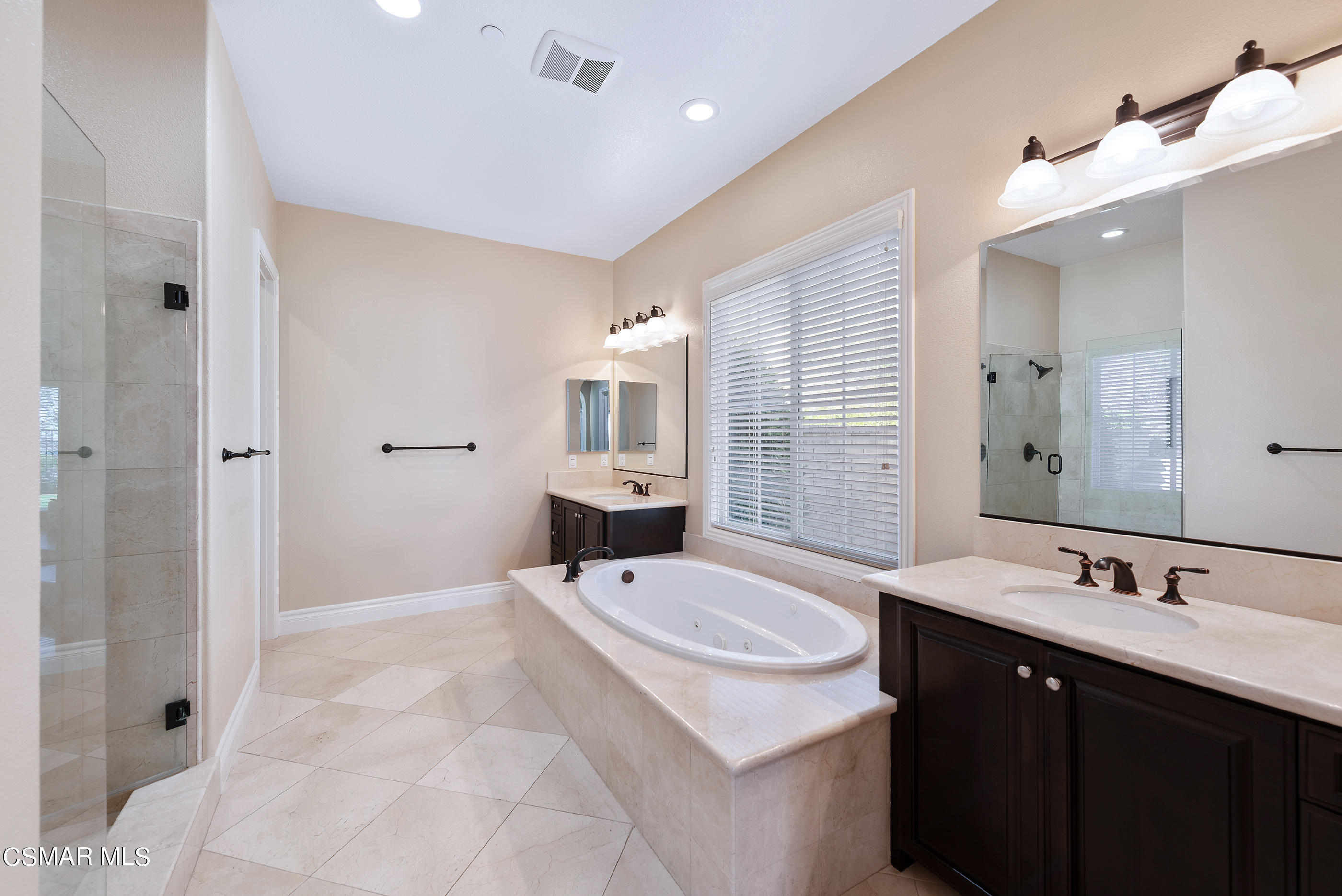 13740 Pinefield Court Moorpark, CA 93021 - Photo 34 of 62 a spacious bathroom with a sink double vanity granite tub shower and a mirror