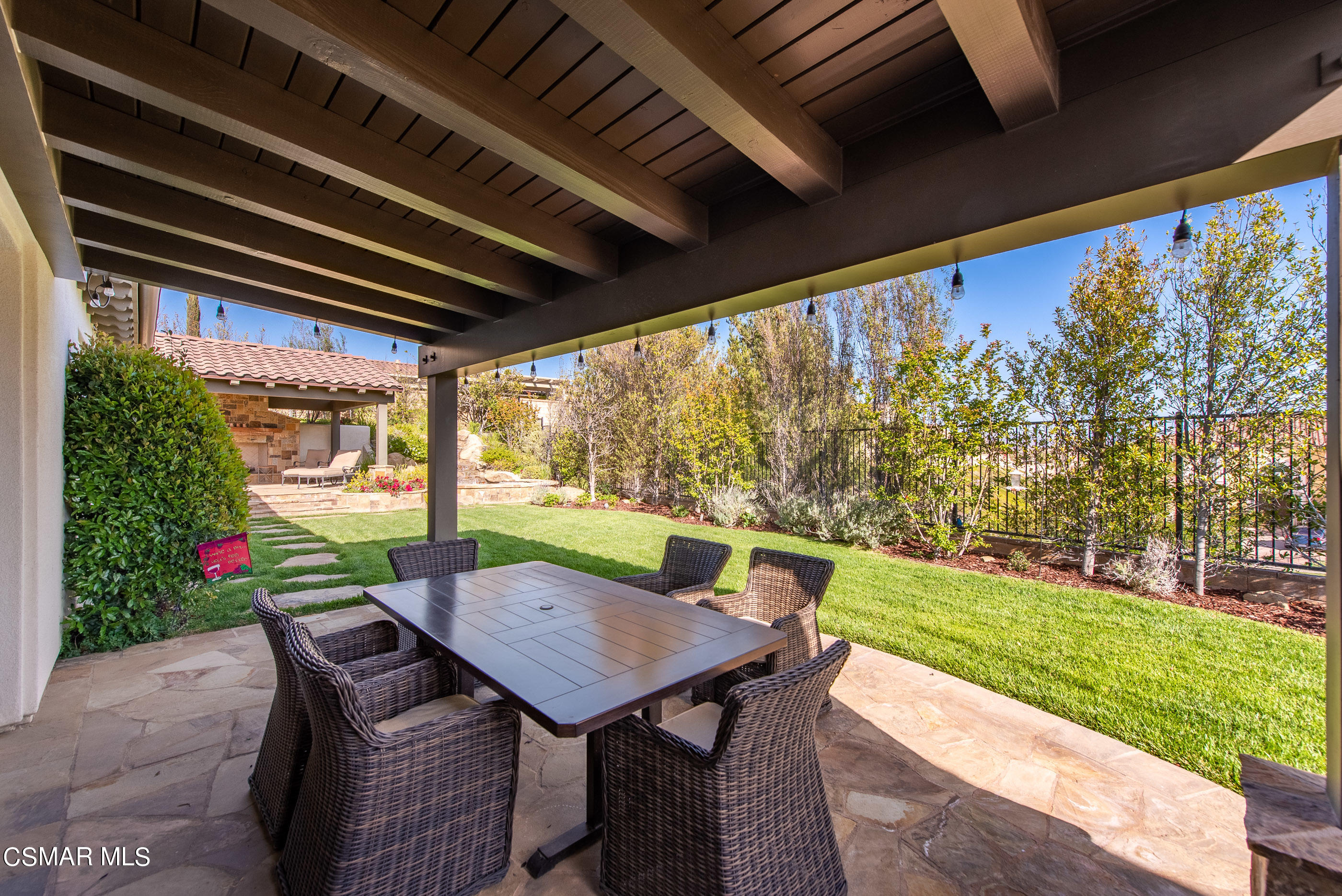 13740 Pinefield Court Moorpark, CA 93021 - Photo 41 of 62 a view of a patio with a table chairs and a backyard
