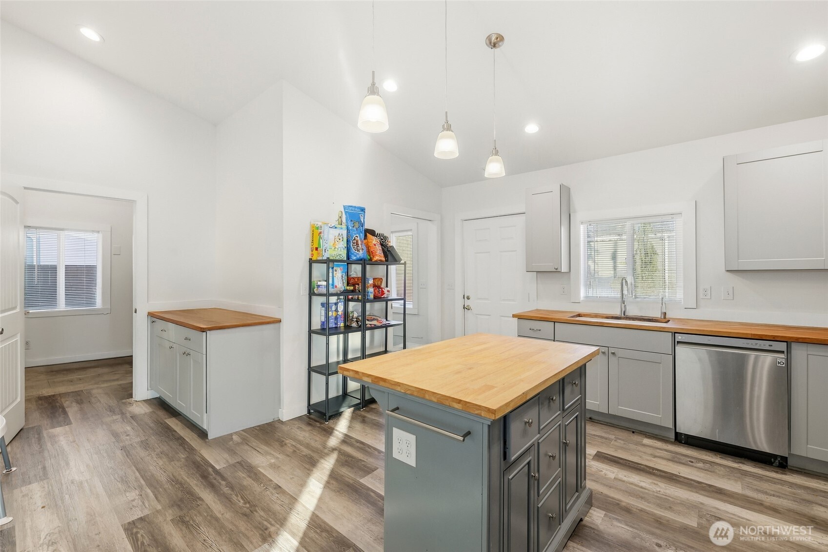 856 Northwest Folsom Street Chehalis, WA 98532 - Photo 12 of 38 a kitchen with a wooden floor and white cabinets
