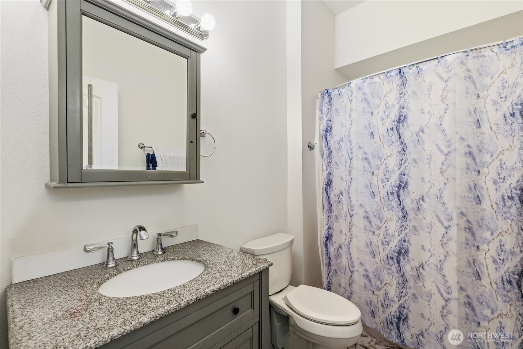 856 Northwest Folsom Street Chehalis, WA 98532 - Photo 25 of 38 a bathroom with a granite countertop sink a toilet and a mirror
