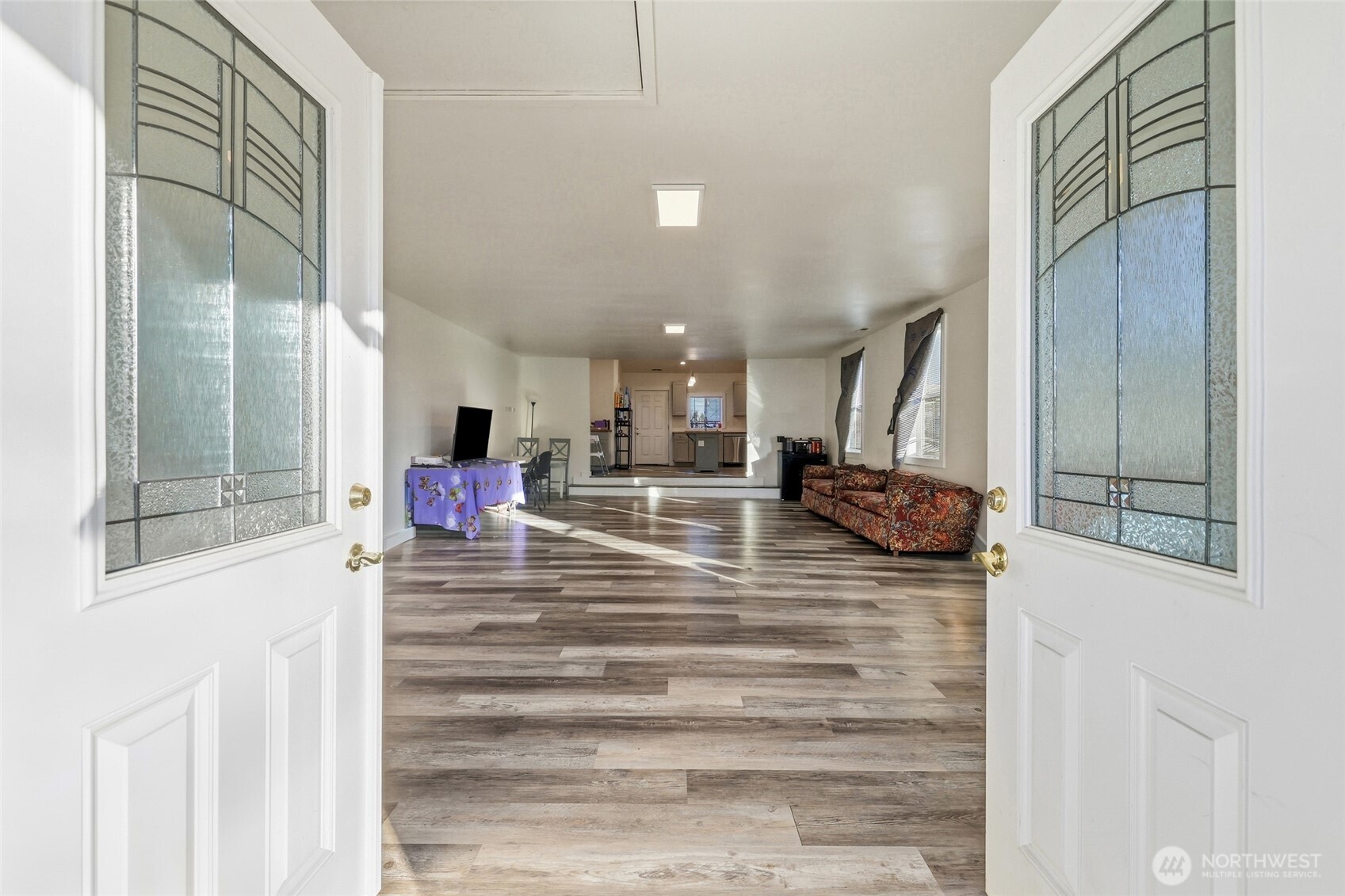 856 Northwest Folsom Street Chehalis, WA 98532 - Photo 3 of 38 a room with lot of painting and a glass door