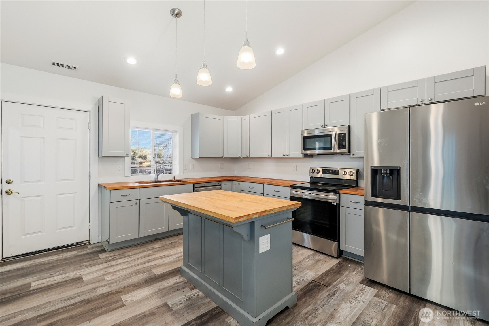 856 Northwest Folsom Street Chehalis, WA 98532 - Photo 9 of 38 a kitchen with kitchen island granite countertop stainless steel appliances and wooden cabinets