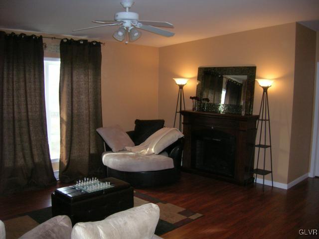 The living room features vaulted ceilings, lighted