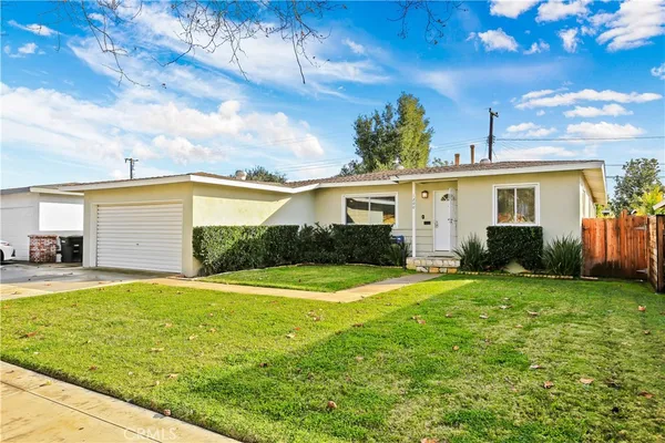 a view of a house with a yard and garage