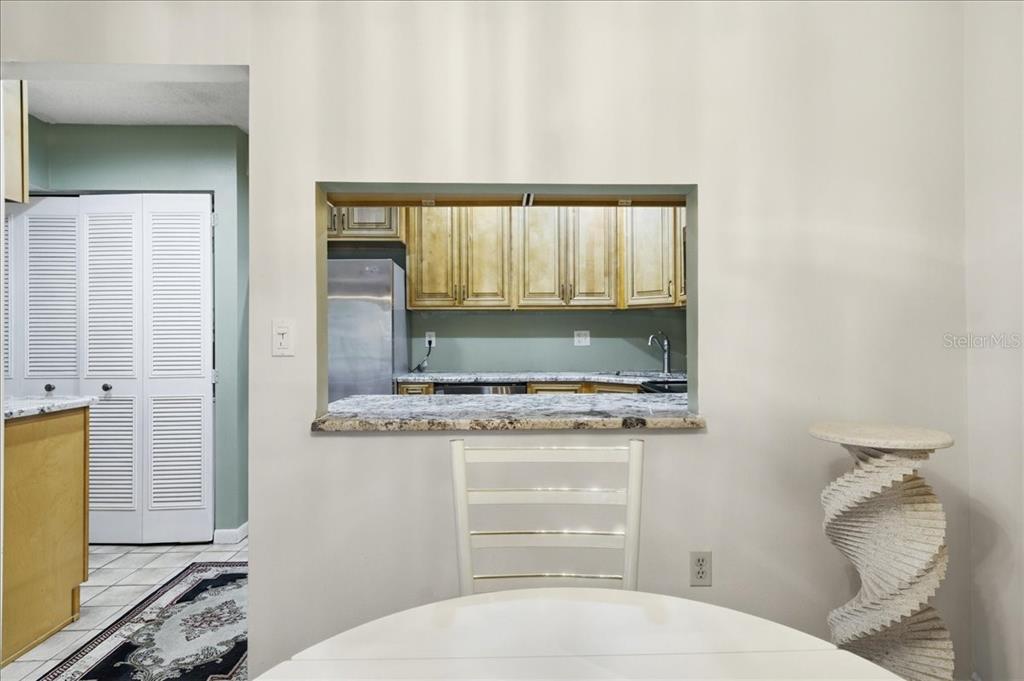 2666 Pine Ridge Way North, Unit C2 Palm Harbor, FL 34684 - Photo 13 of 74 a bathroom with a granite countertop sink and a mirror