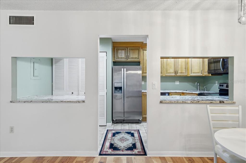 2666 Pine Ridge Way North, Unit C2 Palm Harbor, FL 34684 - Photo 17 of 74 a kitchen with a refrigerator and a stove
