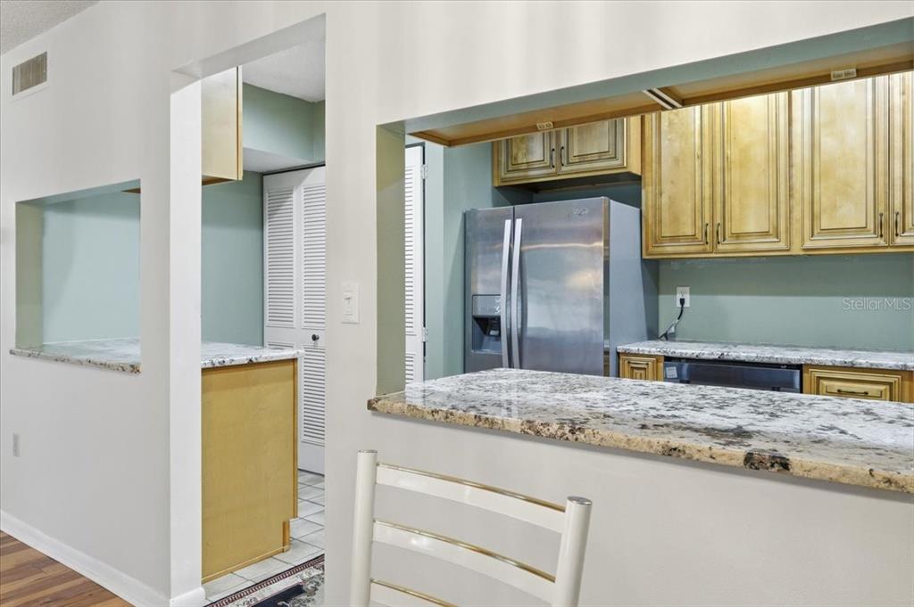 2666 Pine Ridge Way North, Unit C2 Palm Harbor, FL 34684 - Photo 24 of 74 a bathroom with a granite countertop sink and a mirror