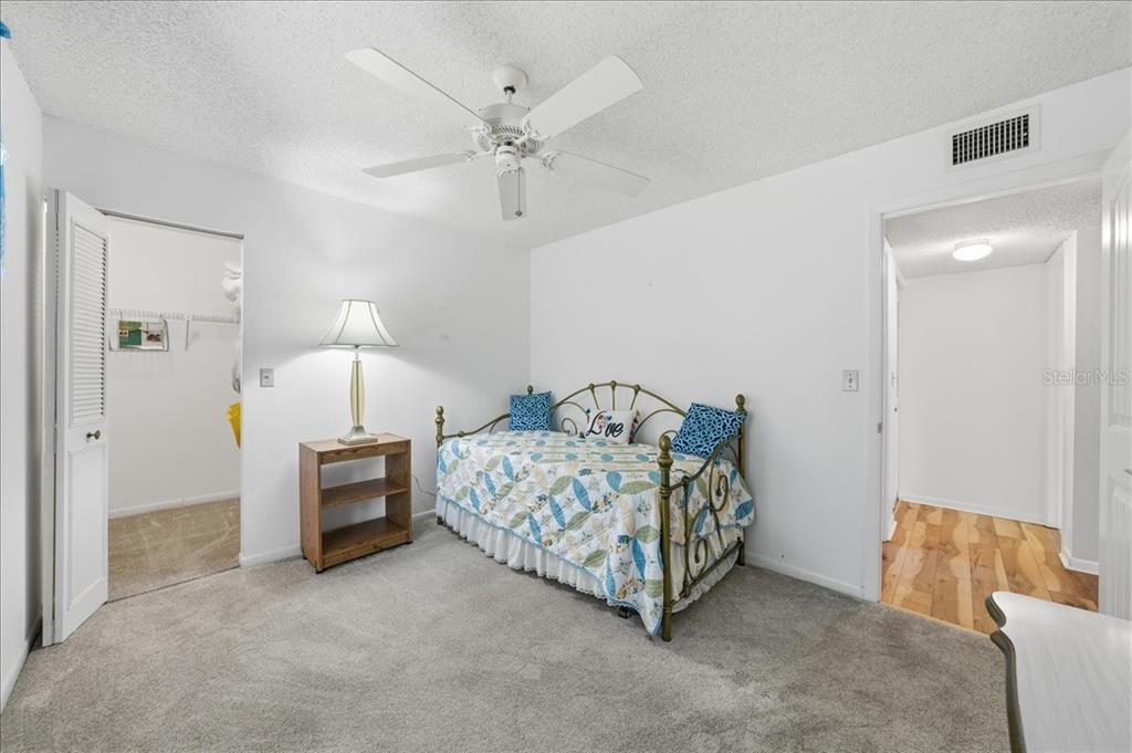 2666 Pine Ridge Way North, Unit C2 Palm Harbor, FL 34684 - Photo 39 of 74 a bed room with a bed and a chair