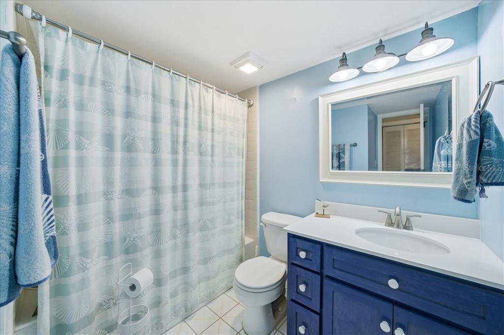 2666 Pine Ridge Way North, Unit C2 Palm Harbor, FL 34684 - Photo 40 of 74 a bathroom with a granite countertop sink toilet and shower