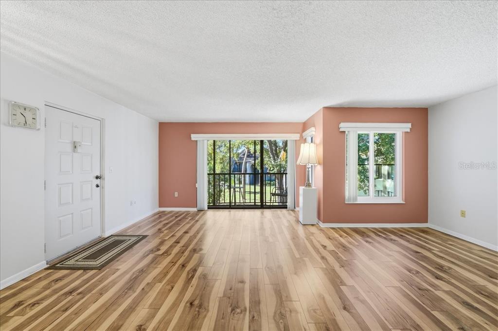 2666 Pine Ridge Way North, Unit C2 Palm Harbor, FL 34684 - Photo 4 of 74 a view of a room with wooden floor and windows