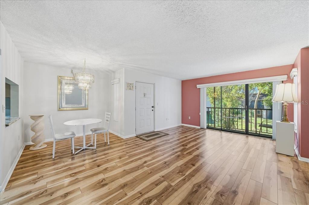 2666 Pine Ridge Way North, Unit C2 Palm Harbor, FL 34684 - Photo 5 of 74 a view of empty room with wooden floor and fan