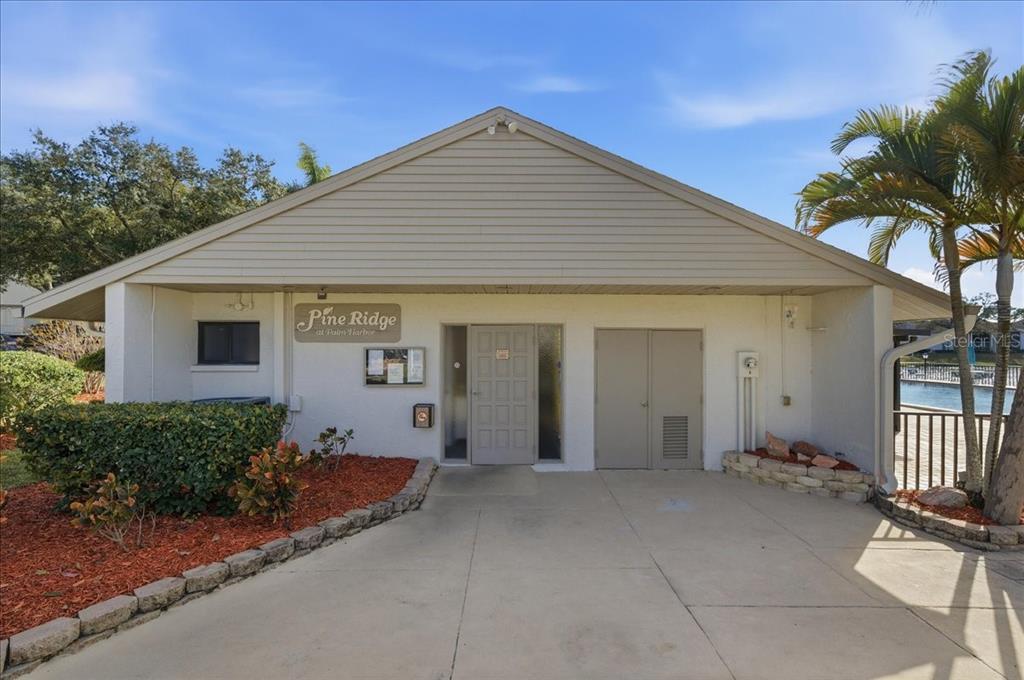 2666 Pine Ridge Way North, Unit C2 Palm Harbor, FL 34684 - Photo 57 of 74 front view of a house with a porch