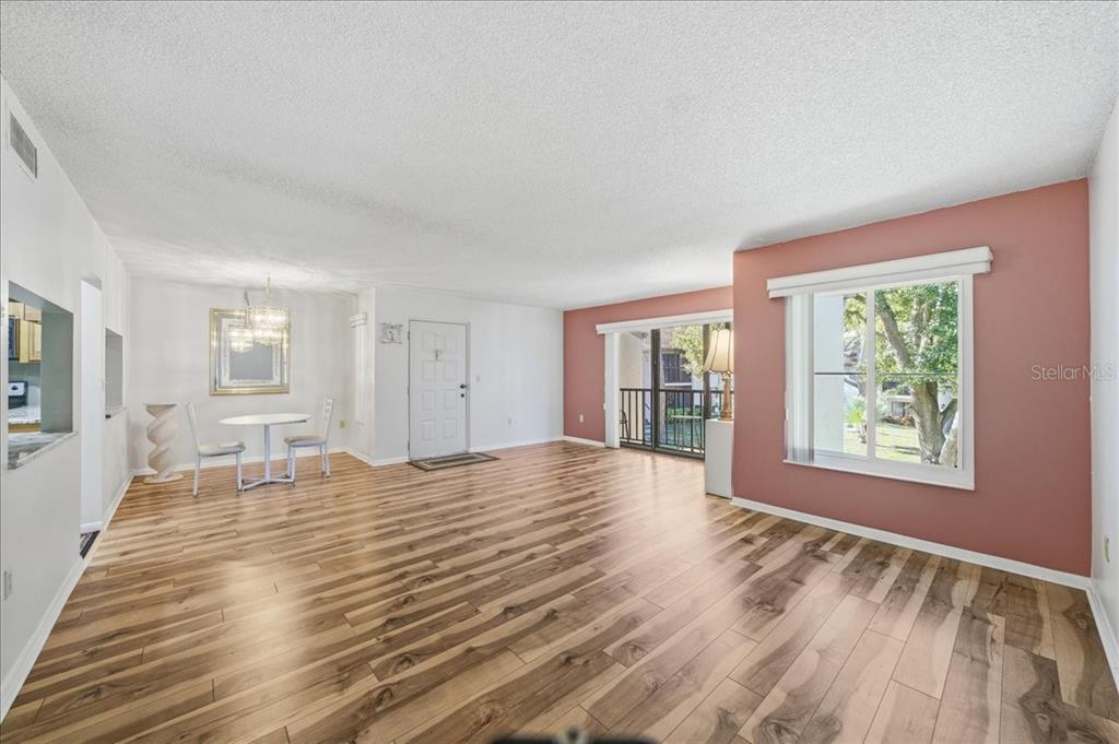 2666 Pine Ridge Way North, Unit C2 Palm Harbor, FL 34684 - Photo 6 of 74 a view of empty room with wooden floor and fan