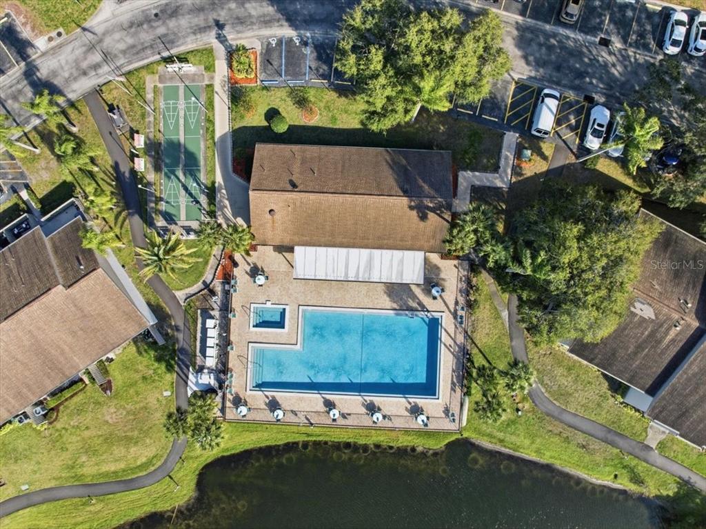 2666 Pine Ridge Way North, Unit C2 Palm Harbor, FL 34684 - Photo 62 of 74 an aerial view of a house with a yard basket ball court and outdoor seating