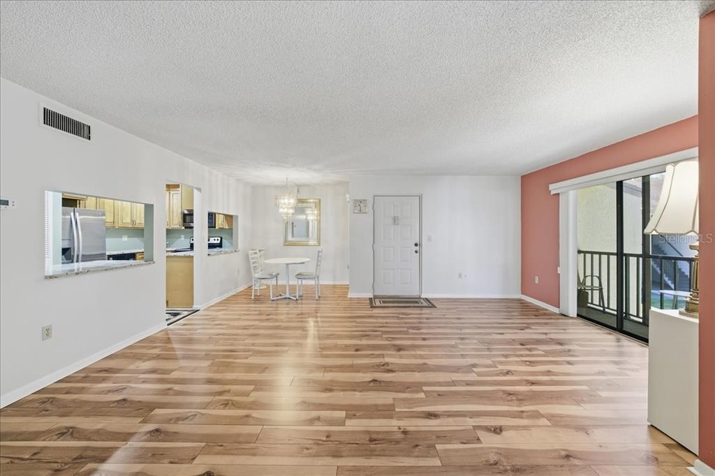 2666 Pine Ridge Way North, Unit C2 Palm Harbor, FL 34684 - Photo 8 of 74 a view of a livingroom with wooden floor and windows