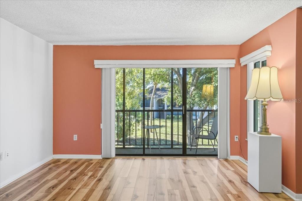 2666 Pine Ridge Way North, Unit C2 Palm Harbor, FL 34684 - Photo 10 of 74 a view of a room with wooden floor and a window
