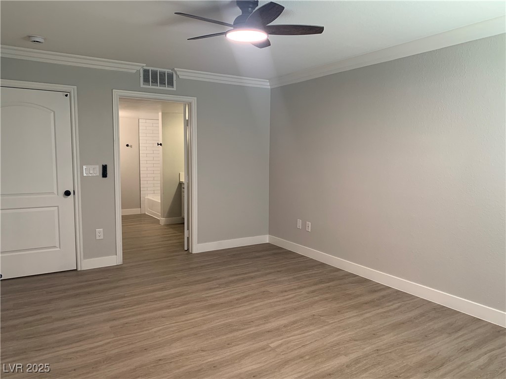 8101 West Flamingo Road, Unit 1102 Las Vegas, NV 89147 - Photo 39 of 54 Bedroom with a ceiling fan, crown molding, light wood finished floors, and a smoke detector