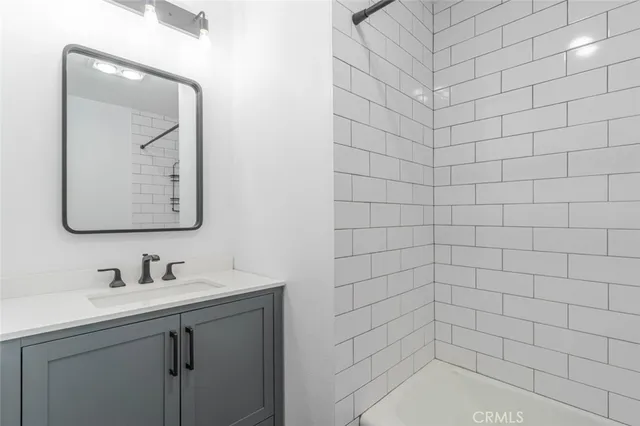 a bathroom with a sink mirror and vanity