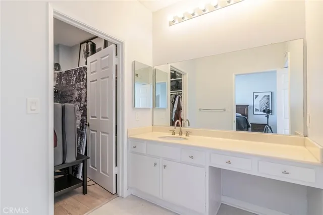 a bathroom with a shower sink and a mirror
