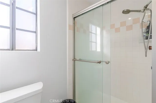 a bathroom with a shower and a toilet
