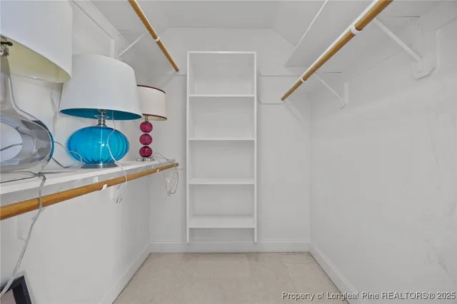 a view of storage and utility room with two washing machine