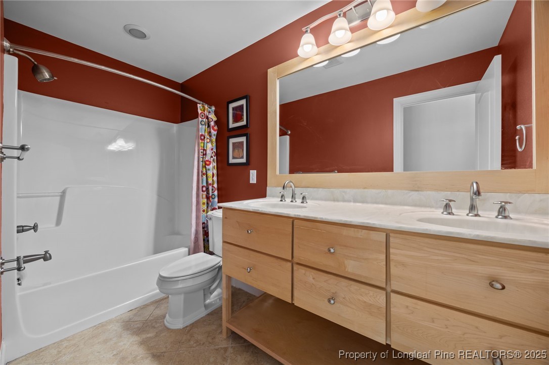 8224 Highway 210 Angier, NC 27501 - Photo 14 of 50 a bathroom with a double vanity sink toilet mirror and bathtub
