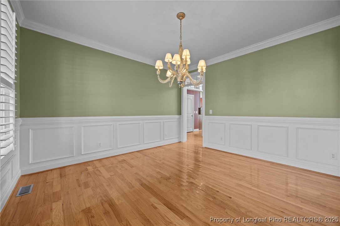 8224 Highway 210 Angier, NC 27501 - Photo 21 of 50 a view of a room with wooden floor and chandelier