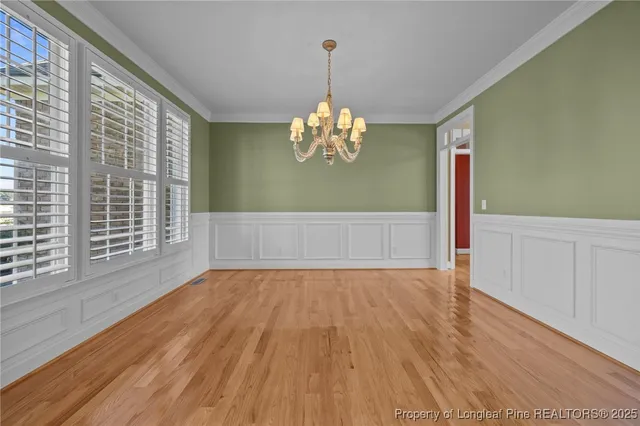a view of a livingroom with wooden floor and a large window