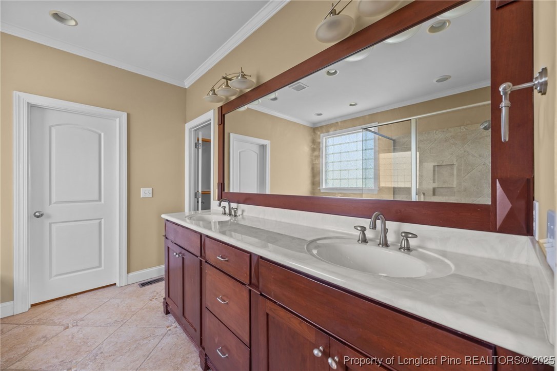 8224 Highway 210 Angier, NC 27501 - Photo 26 of 50 a bathroom with a double vanity sink and a mirror