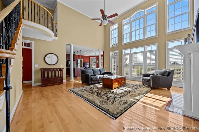 a living room with furniture a rug and a window