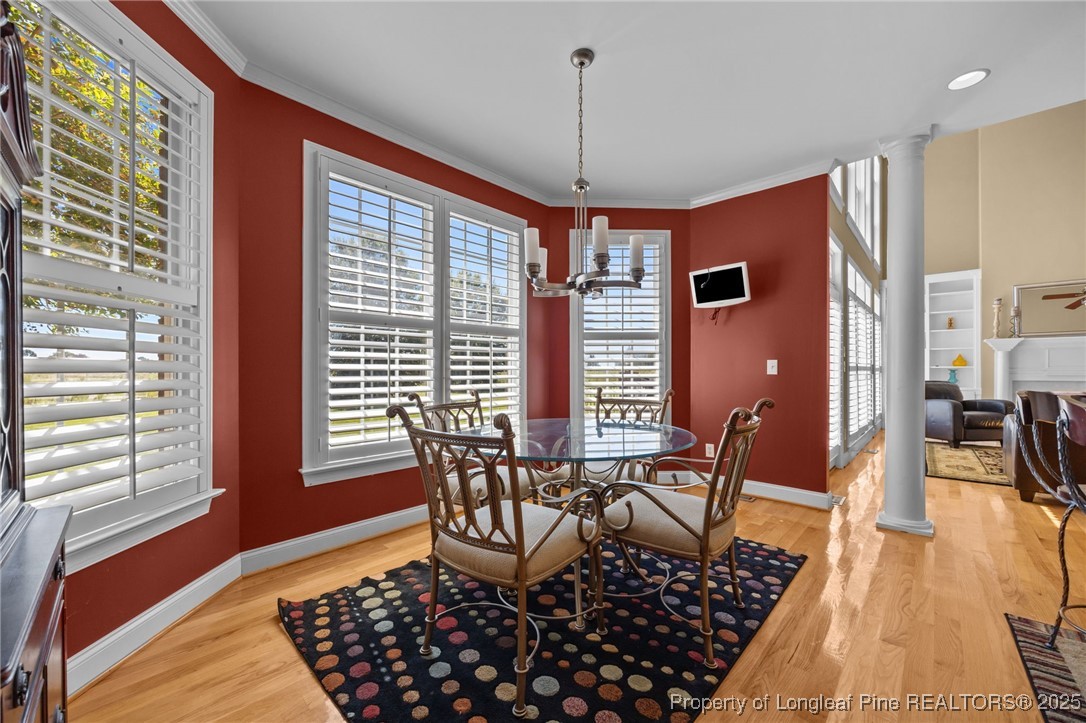 8224 Highway 210 Angier, NC 27501 - Photo 35 of 50 a dining room with furniture a chandelier and wooden floor