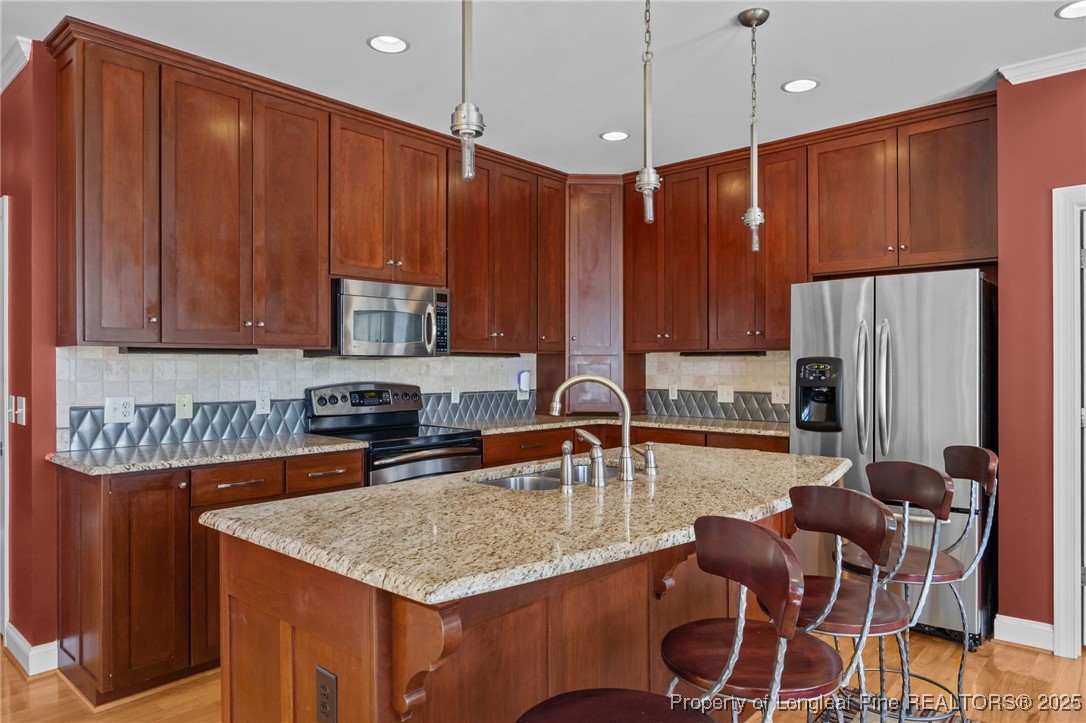 8224 Highway 210 Angier, NC 27501 - Photo 36 of 50 a kitchen with stainless steel appliances granite countertop a table chairs sink refrigerator and microwave