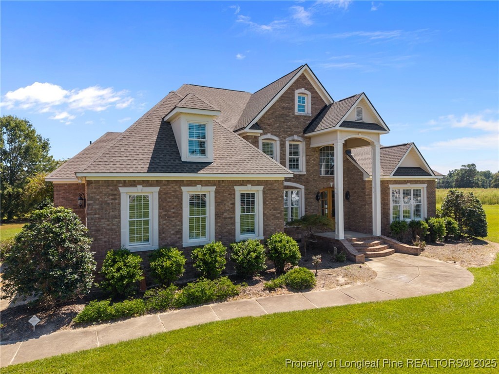 8224 Highway 210 Angier, NC 27501 - Photo 7 of 50 a front view of a house with a yard