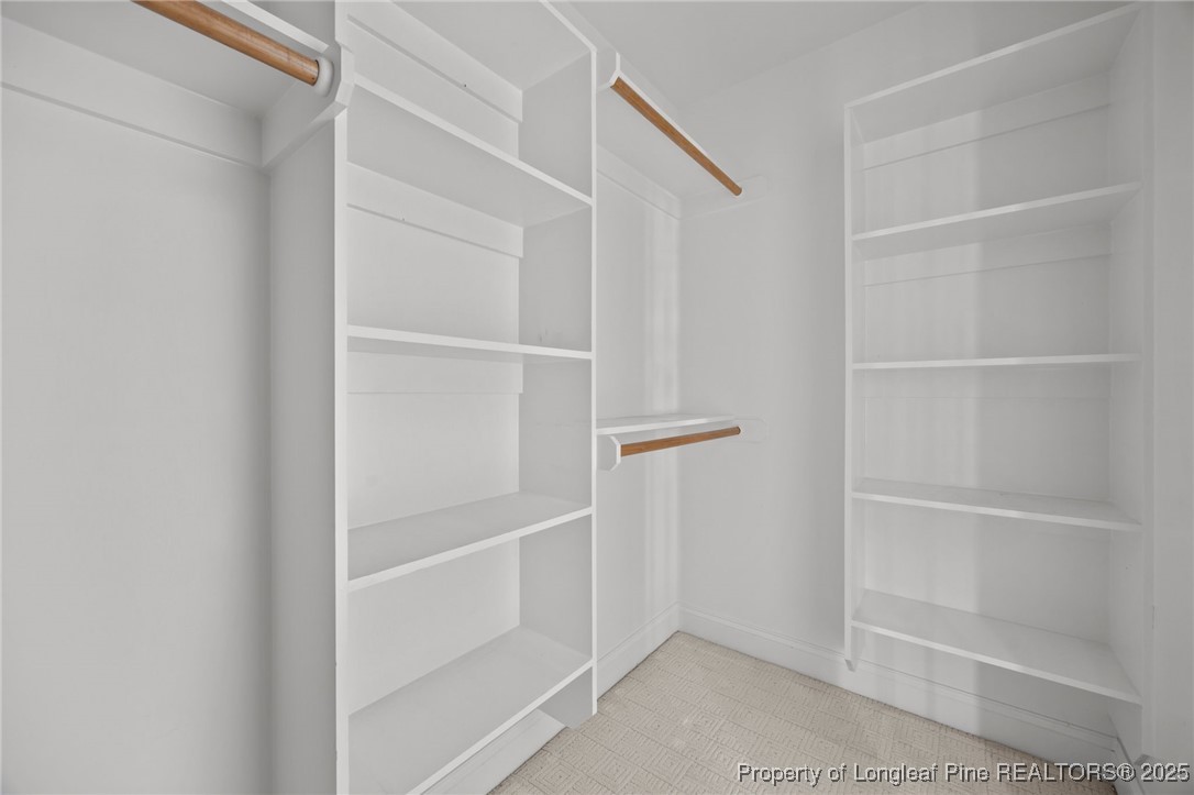 8224 Highway 210 Angier, NC 27501 - Photo 10 of 50 a view of walk in closet with empty racks