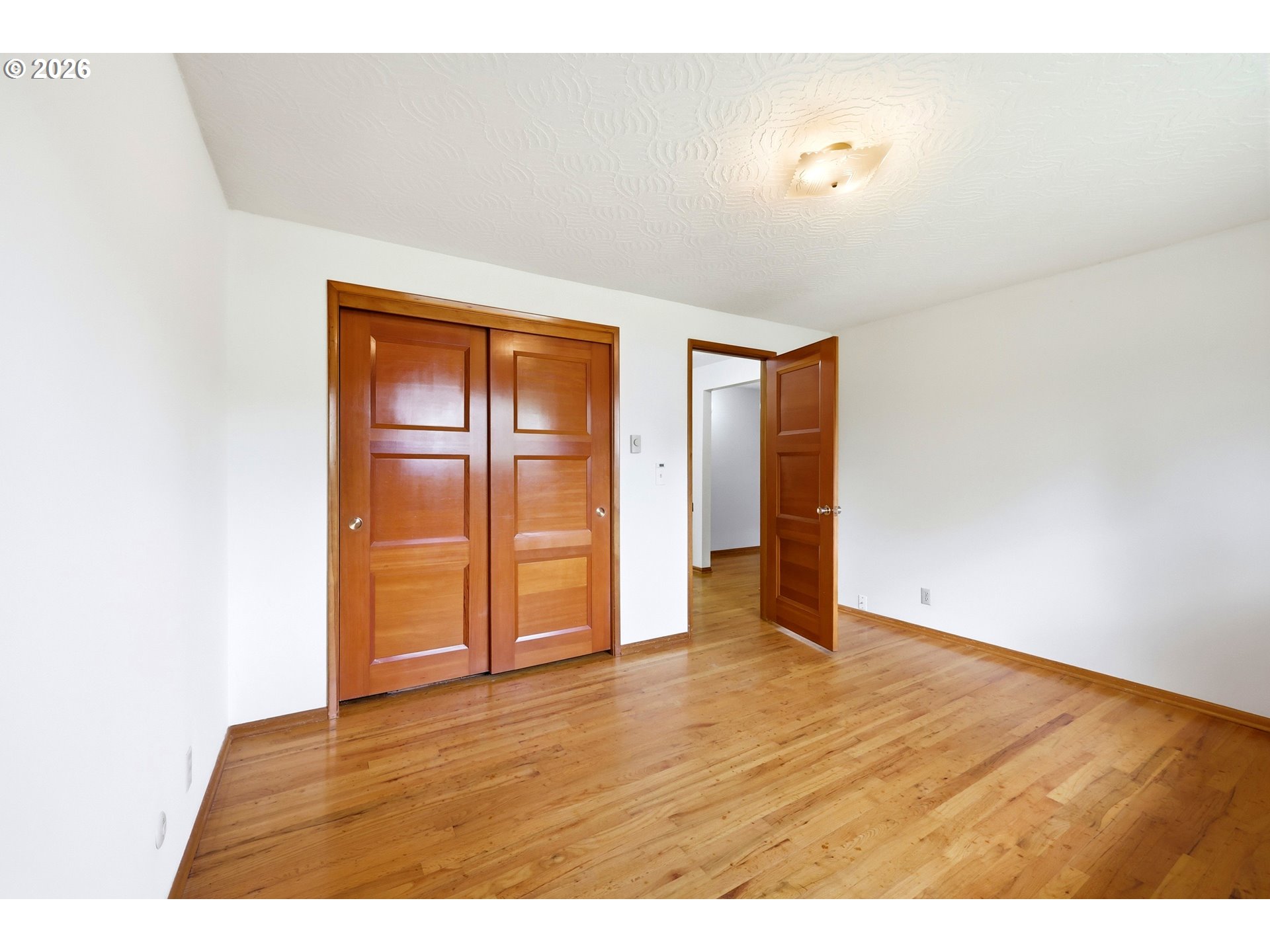 3003 Southeast 162nd Avenue Portland, OR 97236 - Photo 23 of 41 a view of an empty room with wooden floor
