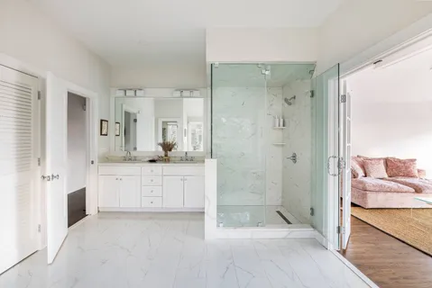 a bathroom with a granite countertop sink mirror and shower