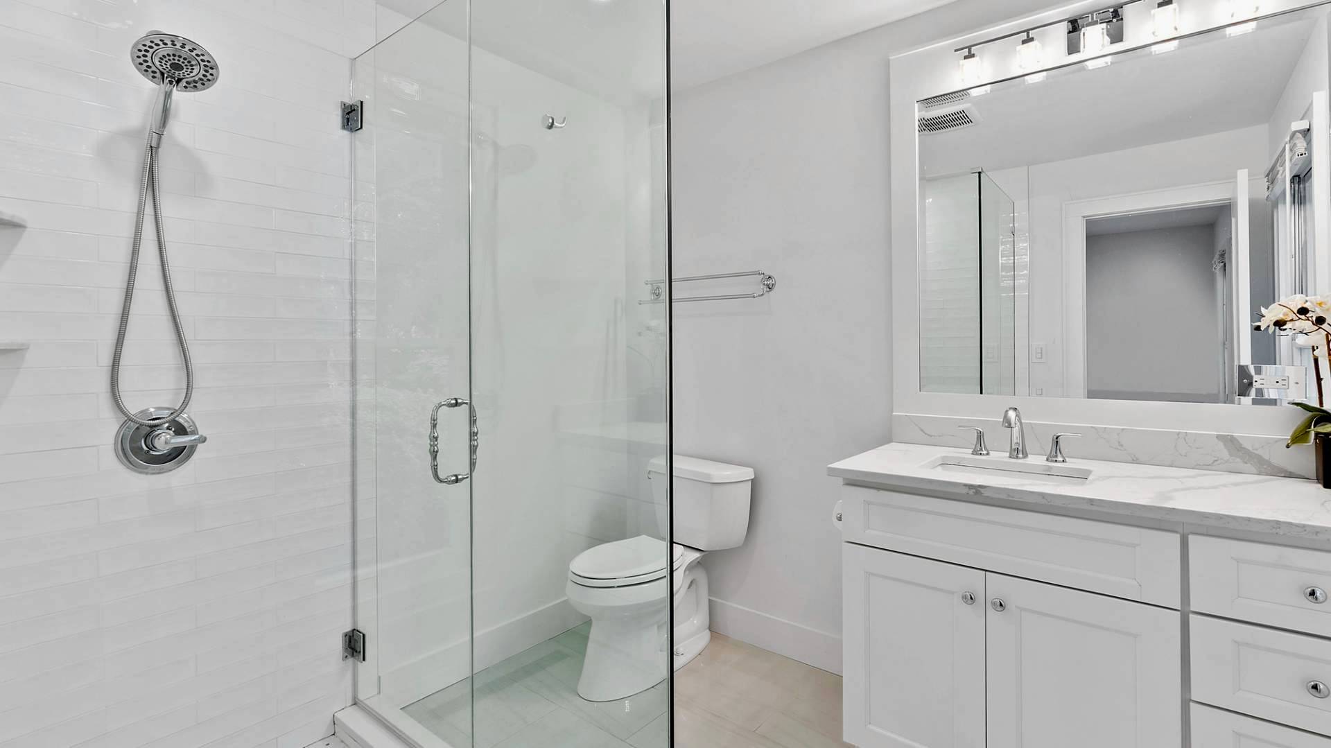 29 Petrel Road Southampton, NY 11968 - Photo 20 of 28 a bathroom with a toilet sink shower and mirror