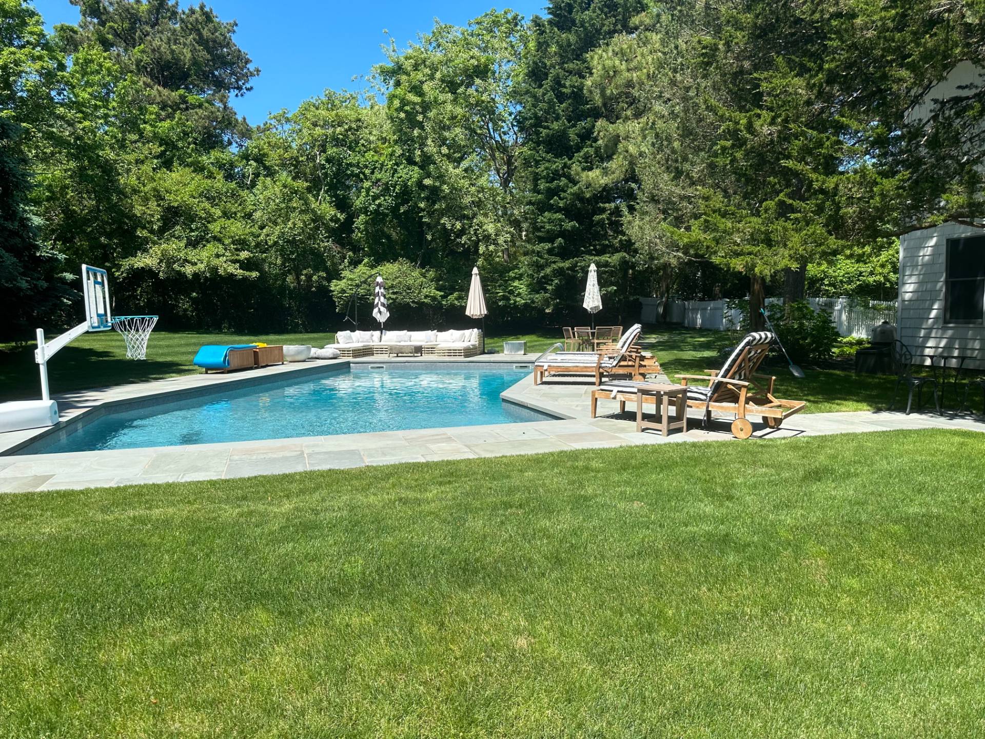 29 Petrel Road Southampton, NY 11968 - Photo 2 of 28 a view of a swimming pool with chairs in the garden