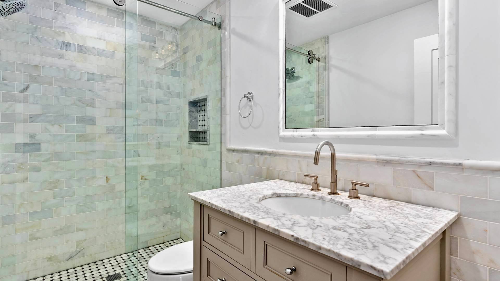 29 Petrel Road Southampton, NY 11968 - Photo 22 of 28 a bathroom with a granite countertop sink a toilet and shower