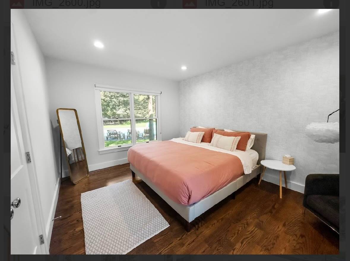 29 Petrel Road Southampton, NY 11968 - Photo 23 of 28 a bedroom with a bed a mirror on dresser and a large window