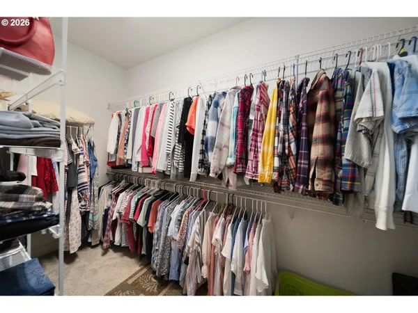 a view of walk in closet with clothes
